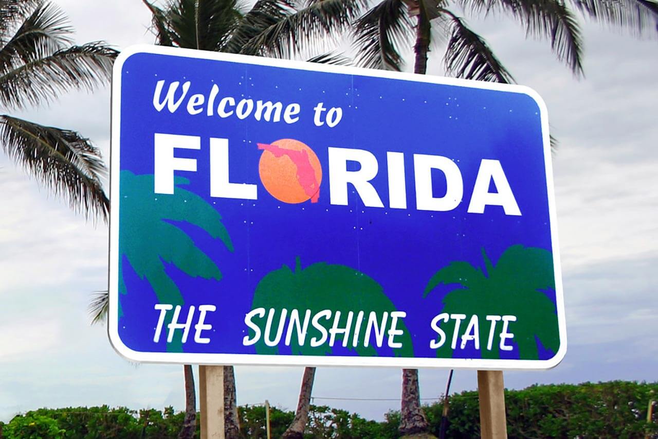 welcome to florida sign that says "welcome to florida, the sunshine state:"