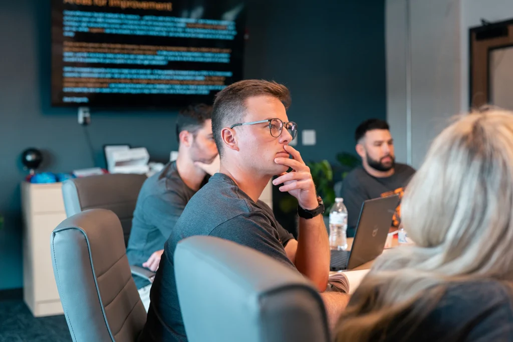 A sales lead intensely considers information in a KCH Transportation conference room.